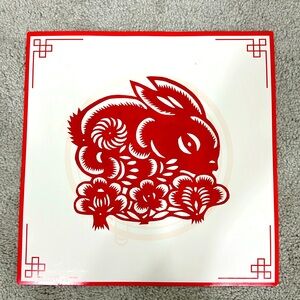 Traditional Chinese handmade paper-cutting art: A rabbit in a flower bush.